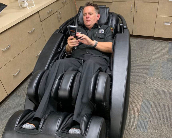 Los Angeles Firefighter using a massage chair from Human Touch.