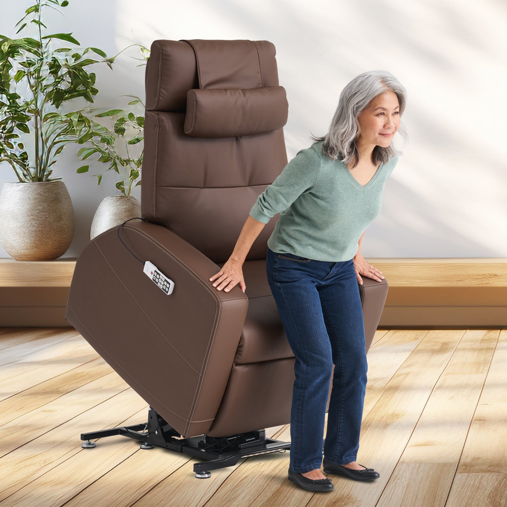 Laevo ZG Chair with Lift Assist shown in brown leather, demonstrating power lift feature in bright modern room setting