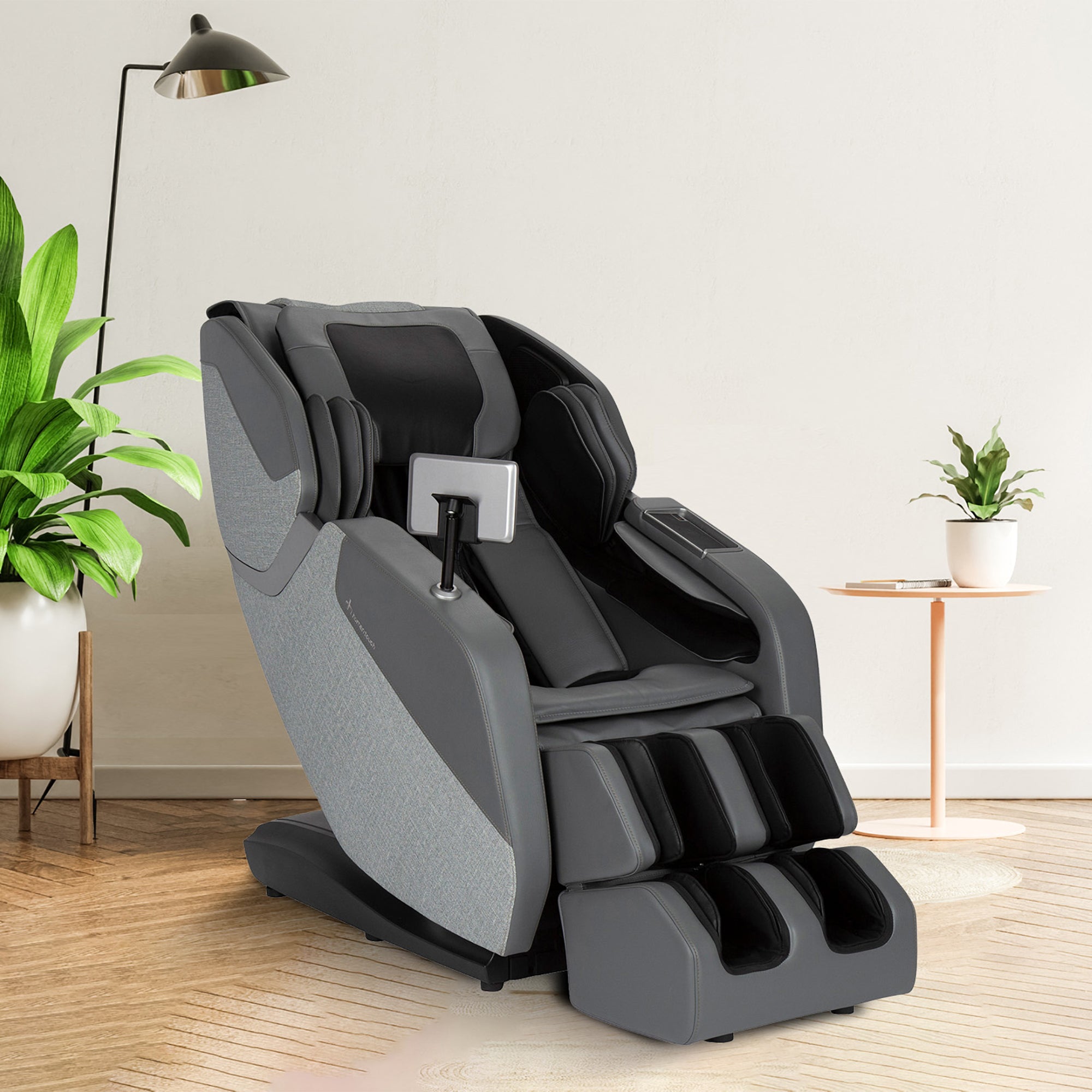 WholeBody ROVE massage chair in gray shown in modern living room with plants and floor lamp